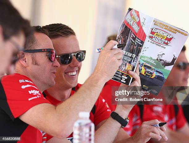 Greg Murphy and James Courtney of the Holden Racing Team are seen during an autograph session ahead of the Bathurst 1000, which is round 11 of the V8...