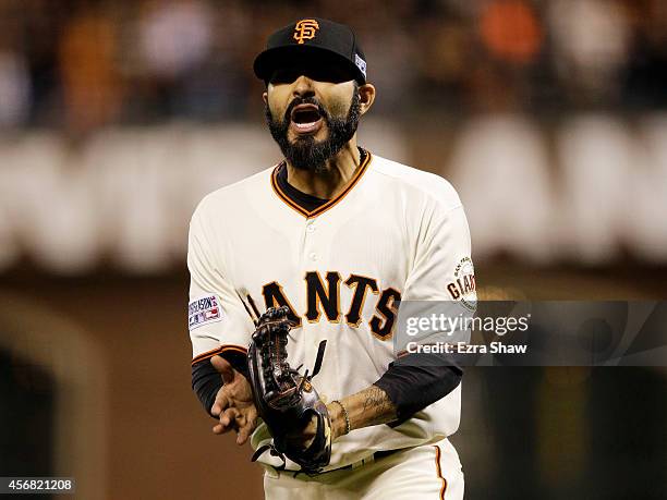 Sergio Romo of the San Francisco Giants celerates after the final out of the eighth inning against the Washington Nationals during Game Four of the...