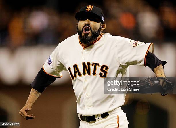 Sergio Romo of the San Francisco Giants celerates after the final out of the eighth inning against the Washington Nationals during Game Four of the...