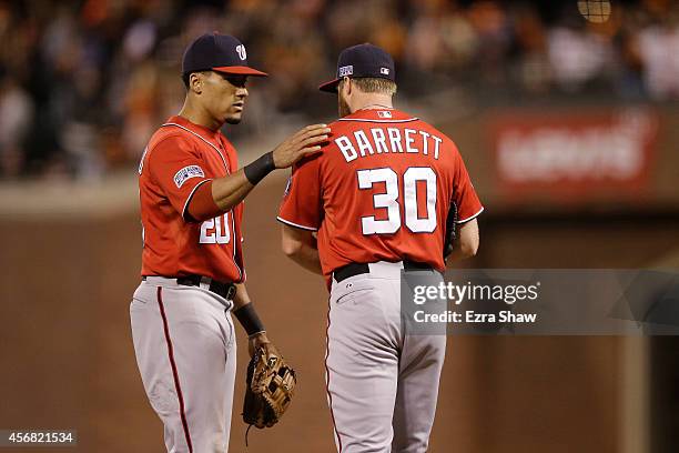 Aaron Barrett talks to Ian Desmond of the Washington Nationals after throwing a wild pitch in the seventh inning against the San Francisco Giants...