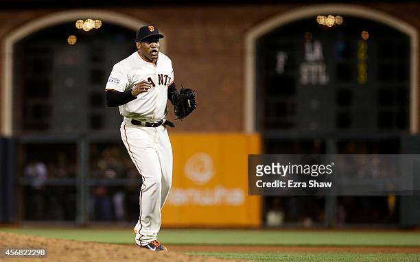 Santiago Casilla of the San Francisco Giants celebrates after the final out of their 3 to 2 win over the Washington Nationals during Game Four of the...