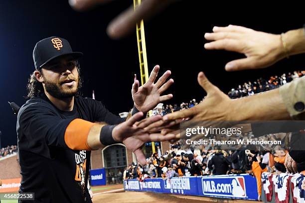 Brandon Crawford of the San Francisco Giants celebrates their 3 to 2 win over the Washington Nationals in Game Four of the National League Division...