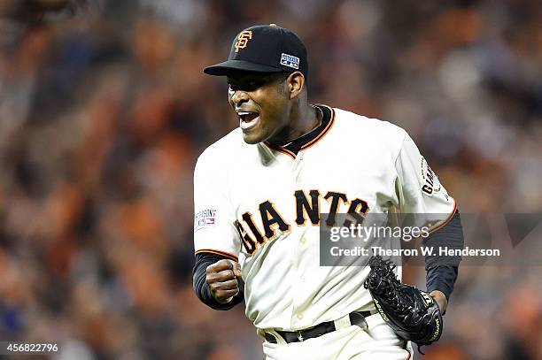 Santiago Casilla of the San Francisco Giants celebrates after the final out of their 3 to 2 win over the Washington Nationals during Game Four of the...