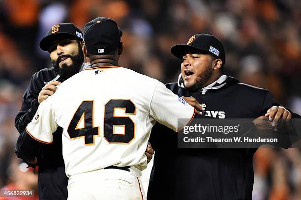 Santiago Casilla of the San Francisco Giants celebrates with teammates after the final out of their 3 to 2 win over the Washington Nationals during...