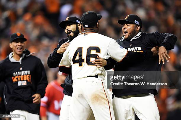 Santiago Casilla of the San Francisco Giants celebrates with teammates after the final out of their 3 to 2 win over the Washington Nationals during...