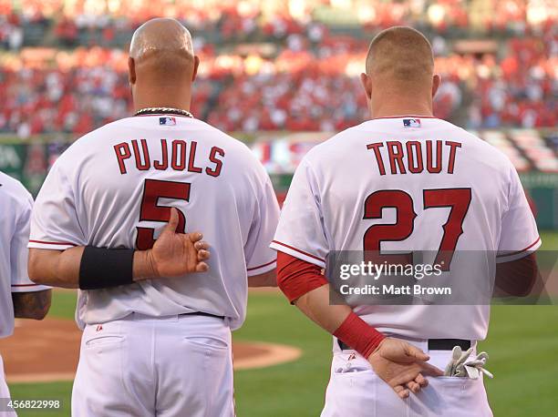 Albert Pujols and Mike Trout of the Los Angeles Angels of Anaheim stand during the national anthem prior to the game against the Kansas City Royals...