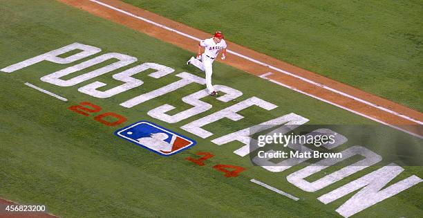 Mike Trout of the Los Angeles Angels of Anaheim runs past the Postseason signage painted on the field during the game against the Kansas City Royals...