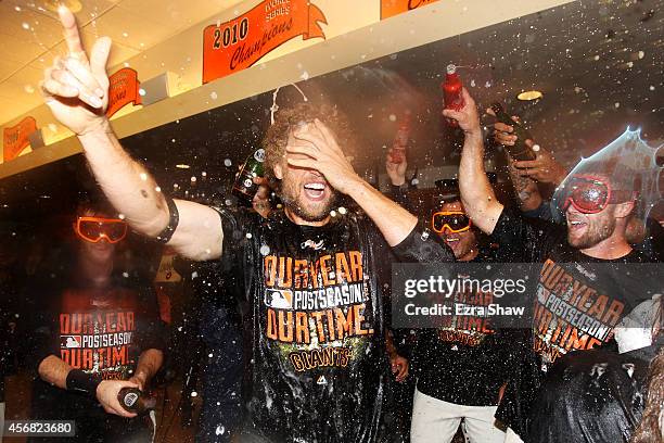 Hunter Pence of the San Francisco Giants celebrates in the locker room after their 3 to 2 win over the Washington Nationals in Game Four of the...