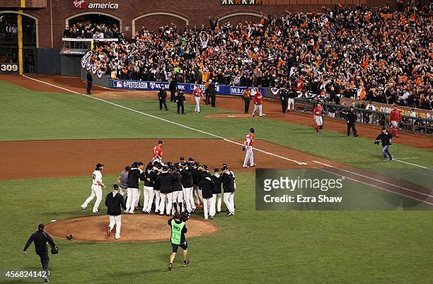 The San Francisco Giants celebrate their 3 to 2 win over the Washington Nationals in Game Four of the National League Division Series at AT&T Park on...