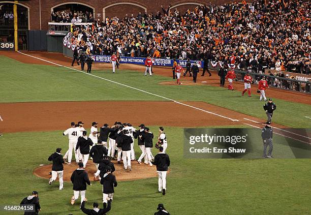 The San Francisco Giants celebrate their 3 to 2 win over the Washington Nationals in Game Four of the National League Division Series at AT&T Park on...