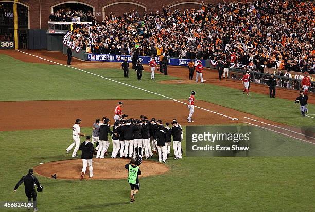 The San Francisco Giants celebrate their 3 to 2 win over the Washington Nationals in Game Four of the National League Division Series at AT&T Park on...