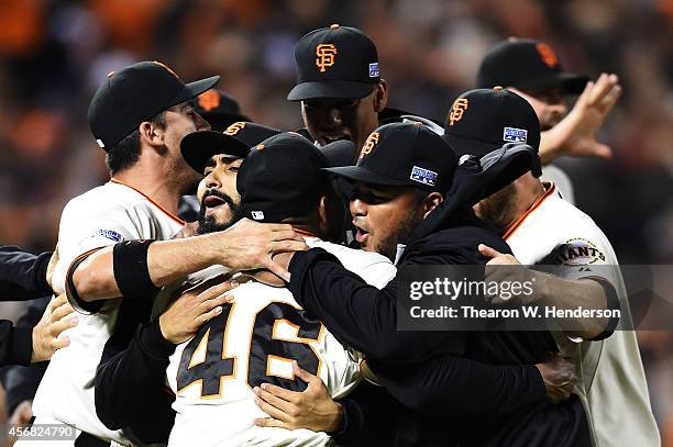 Santiago Casilla of the San Francisco Giants celebrates with teammates after the final out of their 3 to 2 win over the Washington Nationals during...