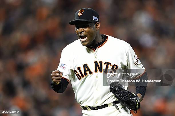 Santiago Casilla of the San Francisco Giants celebrates after the final out of their 3 to 2 win over the Washington Nationals during Game Four of the...