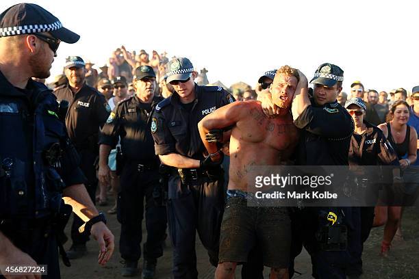 Police lead away a man after an altercation in the "Ute Paddock" camp ground on the second day of the 2014 Deni Ute Muster at the Play on the Plains...