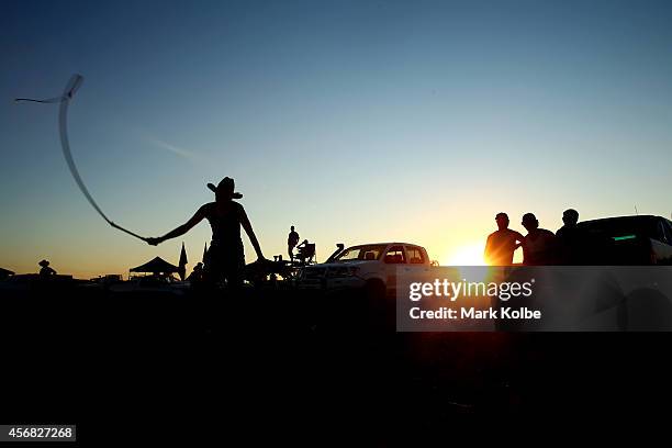 Campers watch on in the late afternoon as a whip is cracked in the "Ute Paddock" camp ground on the first day of the 2014 Deni Ute Muster at the Play...