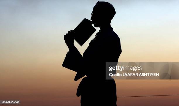 Samaritan prays during the holiday of Sukkot celebrations on Mount Gerizim, near the northern West Bank city of Nablus, on October 8, 2014. Sukkot...