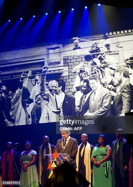 Amsterdam's Mayor Eberhard van der Laan speaks on stage with the Cape Town Opera choir on December 15, 2013 at the Stadsschouwburg theater in...