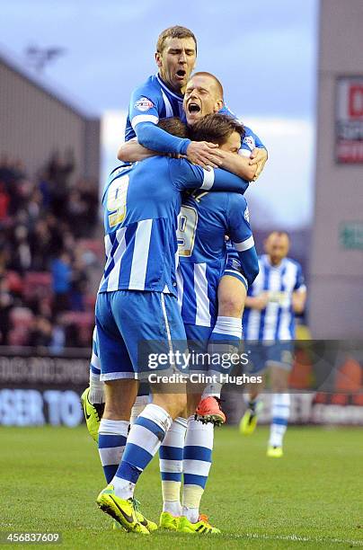 Nick Powell of Wigan Athletic celebrates with team-mates Grant Holt Ben Watson and James McArthur after he scores the second goal of the game for his...