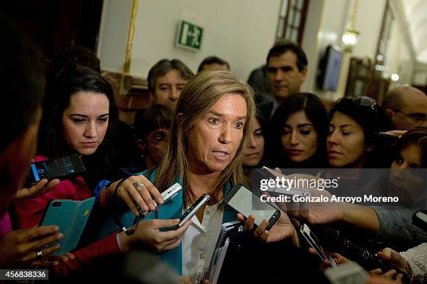 Spanish Health Minister Ana Mato answers questions from the media after attending a plenary session at the Spanish Parliament on October 8, 2014 in...