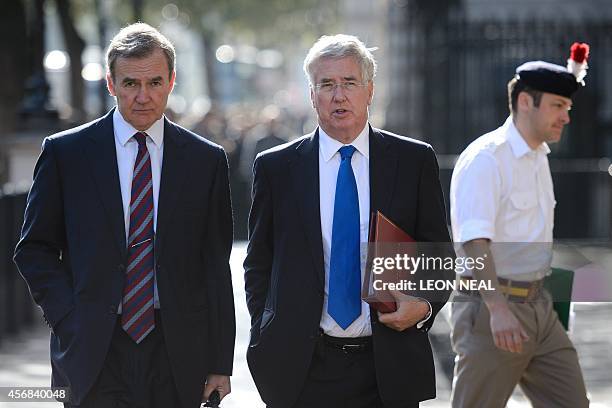 Britain's Secretary of Defence Michael Fallon and Chief of the Defence Staff General Sir Nicholas Houghton arrive at the Cabinet Office in central...