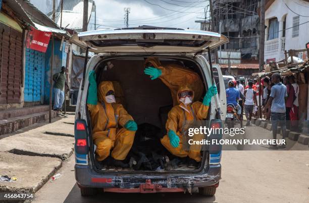 Volunteers arrive to pick up bodies of people who died of the Ebola virus, against a 100 US dollar weekly risk-taking compensation, on October 8,...