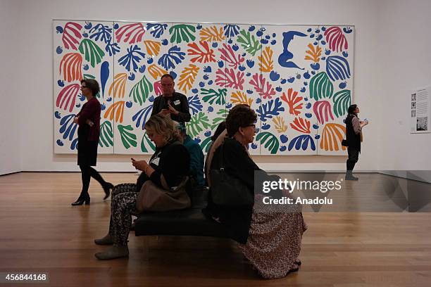 Visitors rest in front of the art work "La Perruche et la Sirène " by the French artist Henri Matisse during the Private View of upcoming exhibition...