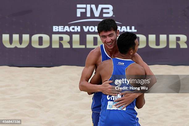 Likejiang Ha and Jian Bao of China celebrate for the point on Day 2 at the 2014 FIVB Beach Volleyball World Tour Xiamen Open men's main draw match on...