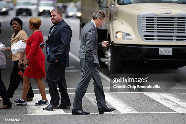 Former U.S. Treasury Secretary Timothy Geithner walks across the street after leaving the U.S. Court of Federal Claims during a lunch break October...