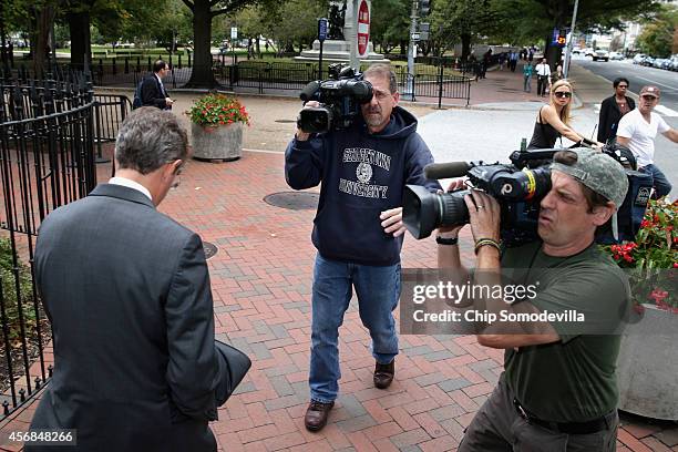 Former U.S. Treasury Secretary Timothy Geithner is followed by television cameramen after leaving the U.S. Court of Federal Claims during a lunch...