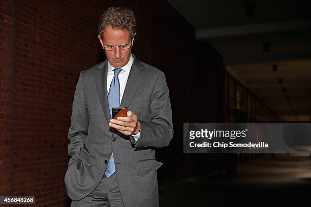 Former U.S. Treasury Secretary Timothy Geithner walks out of the U.S. Court of Federal Claims during a lunch break October 8, 2014 in Washington, DC....