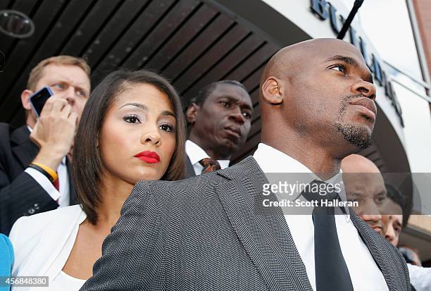 Player Adrian Peterson of the Minnesota Vikings waits with his wife Ashley Brown after making a court appearance at the Montgomery County municipal...