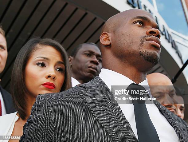 Player Adrian Peterson of the Minnesota Vikings waits with his wife Ashley Brown after making a court appearance at the Montgomery County municipal...