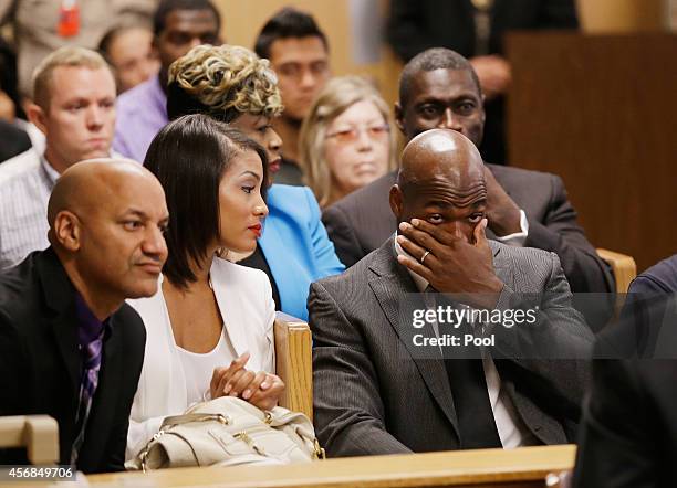 Player Adrian Peterson of the Minnesota Vikings waits with his wife Ashley Brown during a court appearance at the Lee G. Alworth Building and the...