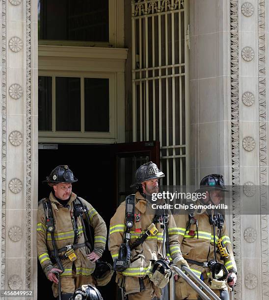 District of Columbia firefighters stand in the doorway of the Treasury Department Annex, next door to the U.S. Court of Federal Claims October 8,...
