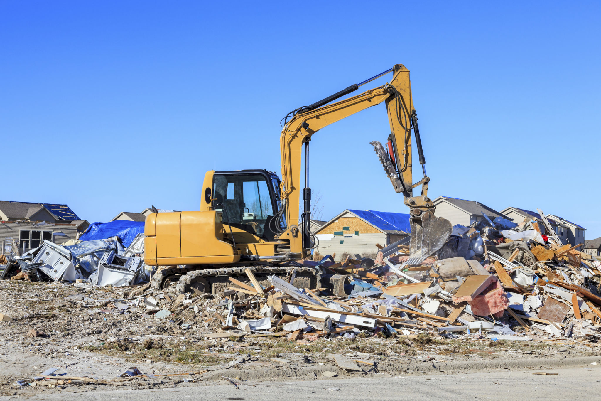 Backhoe cleaning up tornado damage Backhoe cleaning up tornado damage