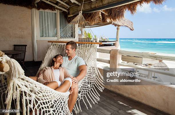 happy young couple smiling at each other - tropical beach couple stock pictures, royalty-free photos & images