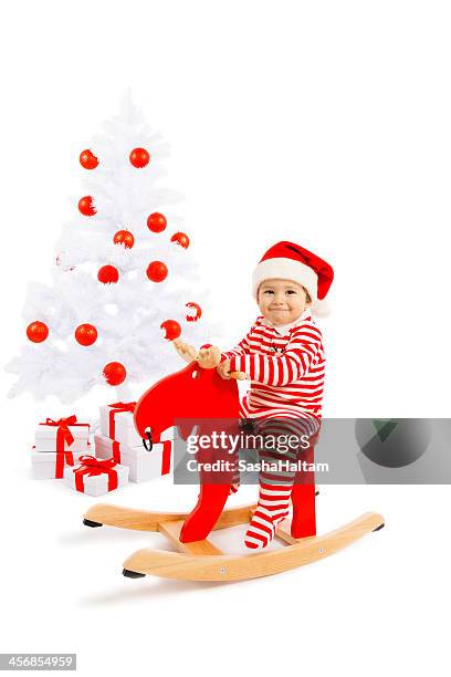 santa baby with decorated christmas tree - eenjarig plantenkenmerk stockfoto's en -beelden