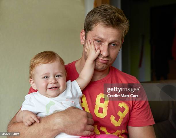 baby girl slapping her uncle - tired parent stock pictures, royalty-free photos & images