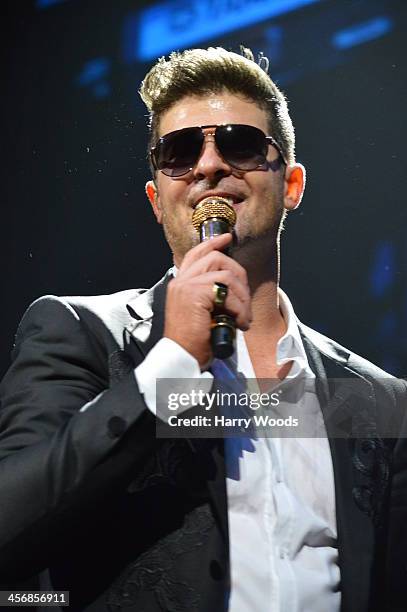 Robin Thicke performs onstage at KISS 108's Jingle Ball 2013 at TD Banknorth Garden on December 14, 2013 in Boston, Massachusetts.
