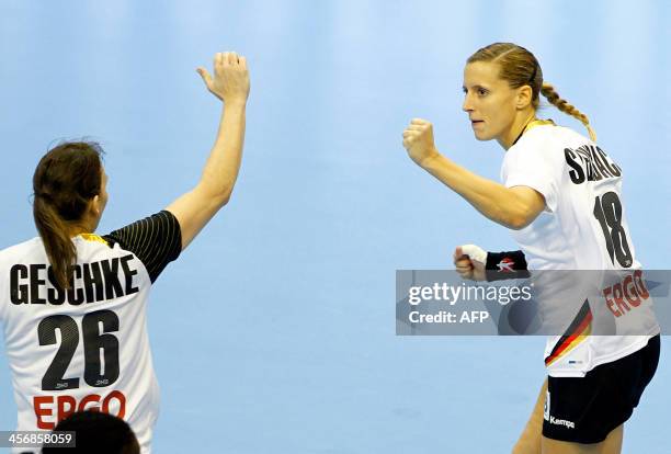 Germany's Angie Geschake and Laura Steinbach celebrate during their Women's Handball World Championship 2013 eight-final match Germany vs Angola on...