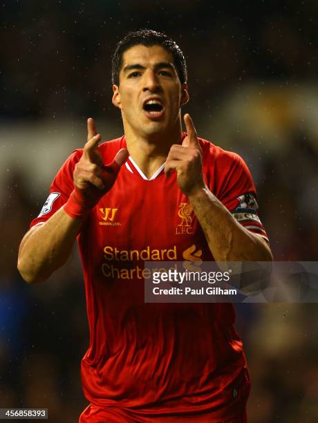 Luis Suarez of Liverpool celebrates scoring their fourth goal during the Barclays Premier League match between Tottenham Hotspur and Liverpool at...
