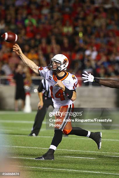 Quarterback Travis Lulay of the BC Lions passes the ball against the Ottawa Redblacks during a CFL game at TD Place Stadium on October 8, 2014 in...