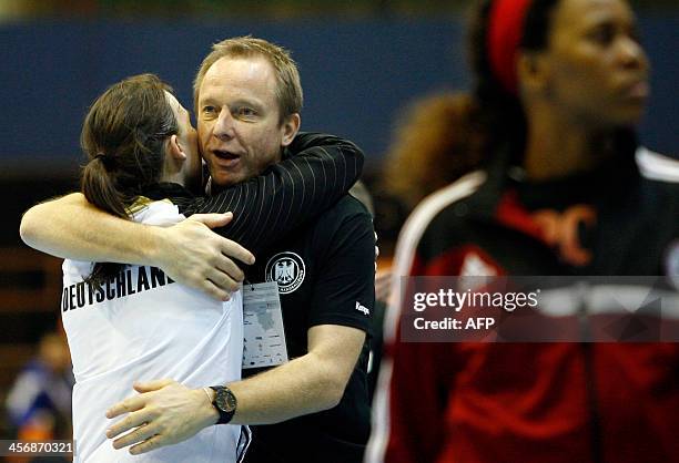 Germany's Angie Geschake celebrates with her coach Nowak Maik after the Women's Handball World Championship 2013 match Germany vs Angola on December...