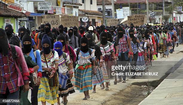Thousands of Zapatista militias march during a demostration on October 8, 2014 in San Cristobal de las Casas, Chiapas state, to demand justice in the...