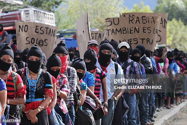 Zapatista militias march during a demostration on October 8, 2014 in San Cristobal de las Casas, Chiapas state, to demand justice in the case of the...