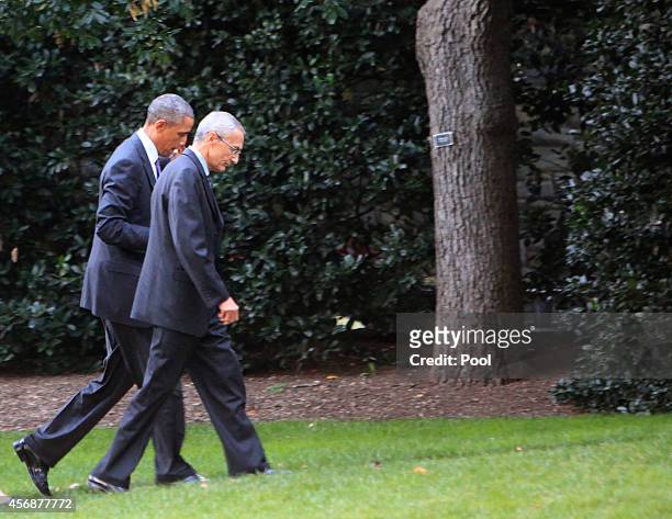 President Barack Obama and John Podesta, counselor to the president, walk to the Oval Office after returning from a meeting at the Pentagon on...