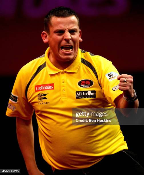 Dave Chisnall of England celebrates after winning a leg during his first round macth against John Henderson of Scotland day three of the...