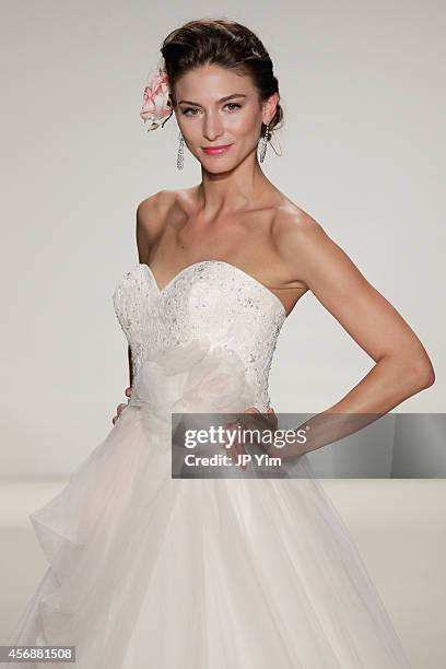 Model walks the runway wearing Disney Fairy Tale Weddings by Alfred Angelo Collection at EZ Studios on October 8, 2014 in New York City.