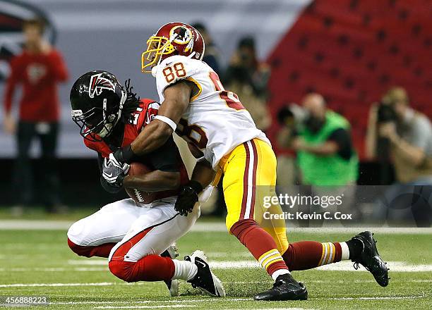 Desmond Trufant of the Atlanta Falcons intercepts a pass intended for Pierre Garcon of the Washington Redskins at Georgia Dome on December 15, 2013...