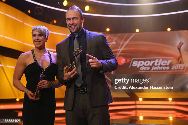 Christina Obergfoell and Robert Harting pose with their Athlete of the Year 2013 award after the Sportler des Jahres 2013 gala at the Kurhaus...